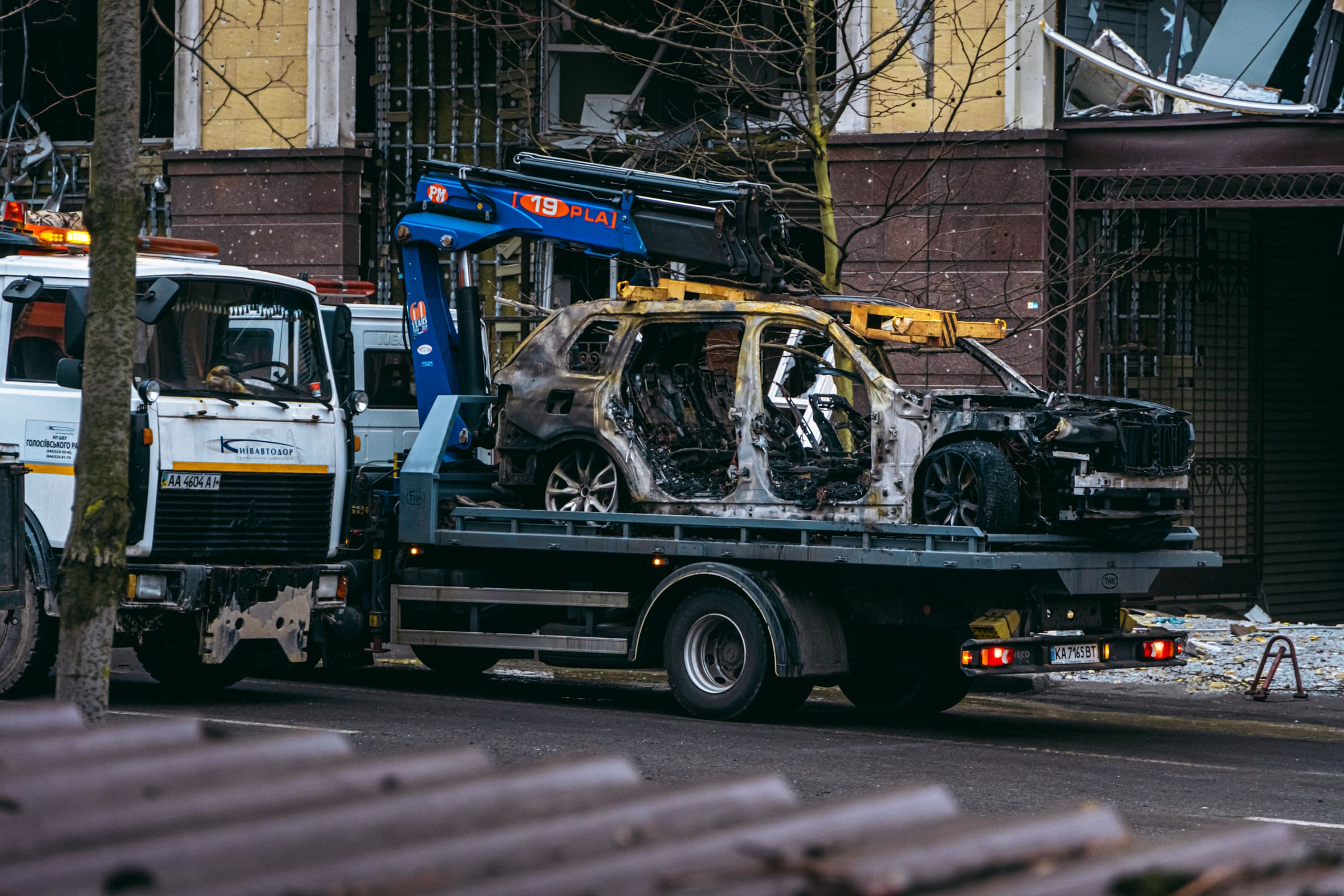A burned car loaded on a flatbed after accident towing