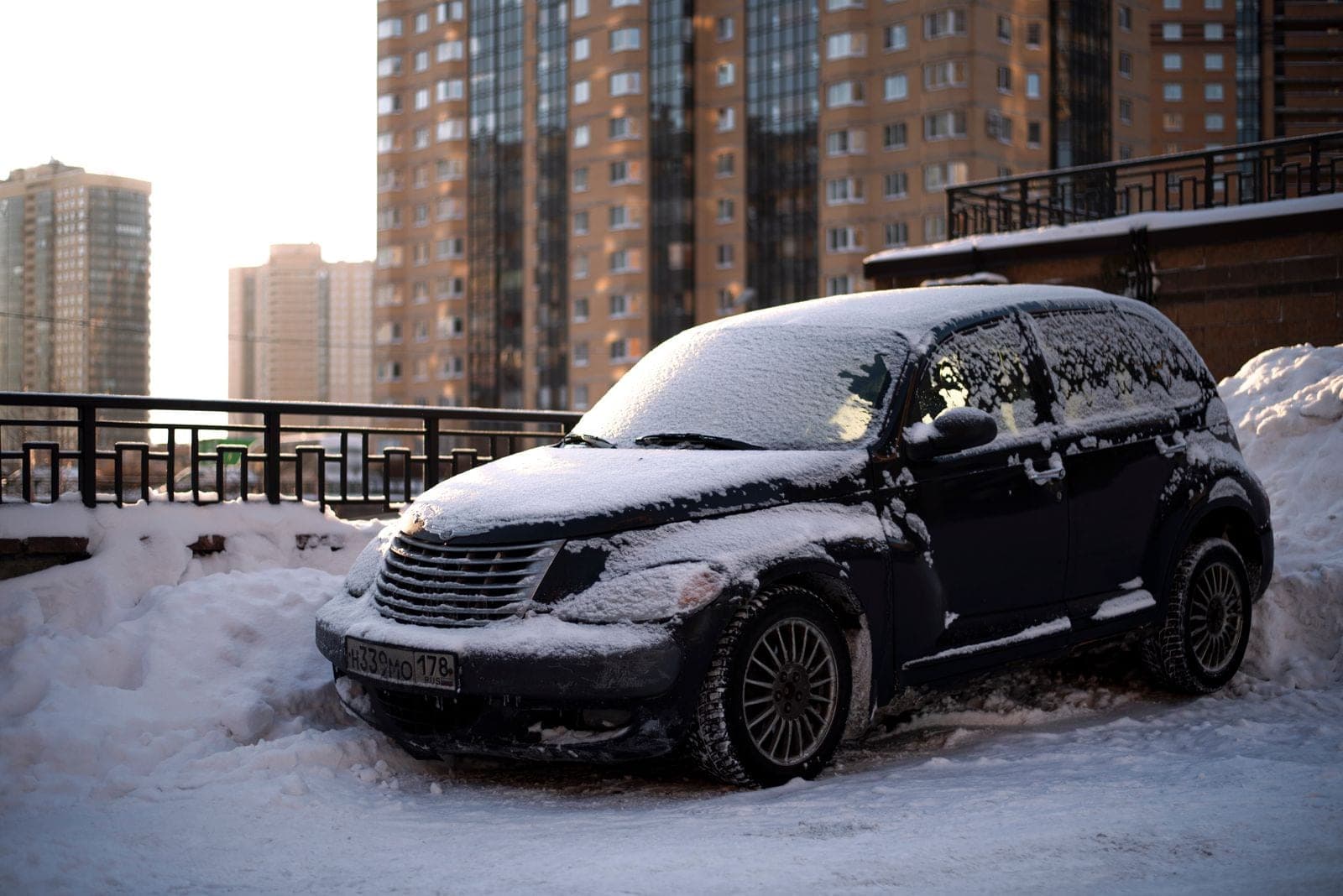 A snow-covered car parked