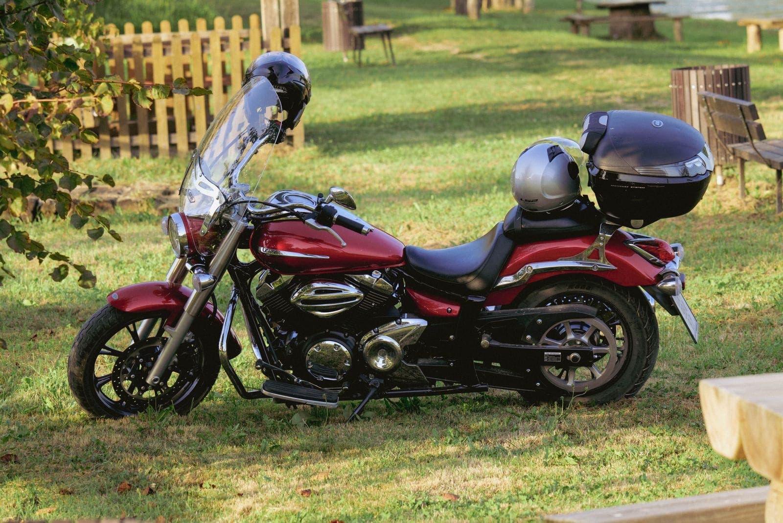A sleek red motorcycle parked on grass